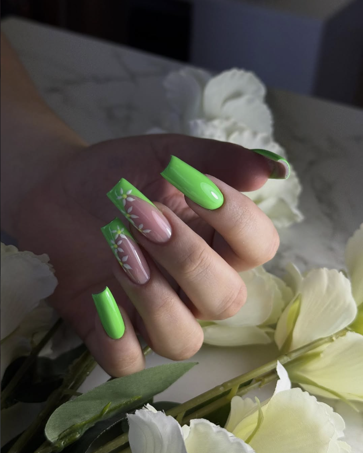 Neon green nails with daisy floral art